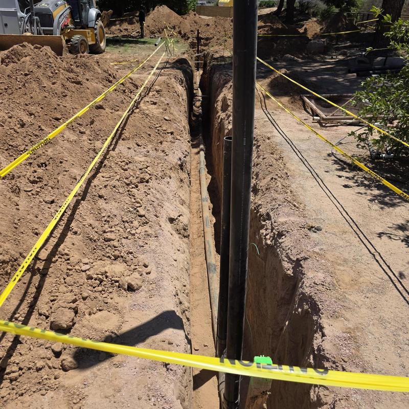 Sewer line trench excavation with caution tape