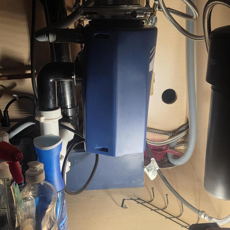 Garbage disposal unit installed under kitchen sink