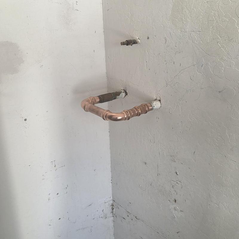 Copper water softener loop piping installation on wall