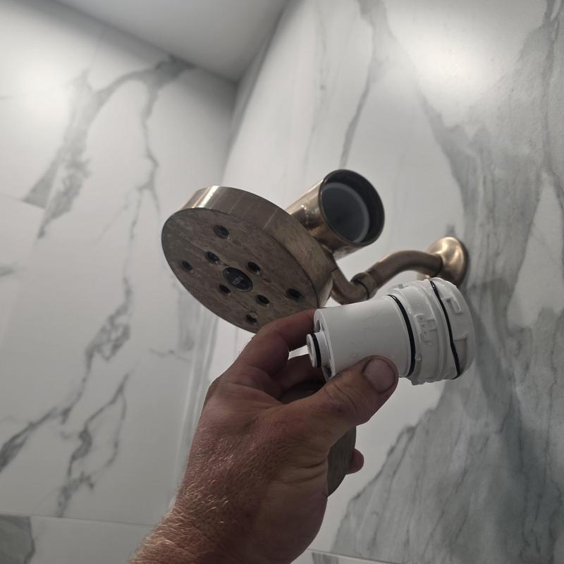 Shower head filter being cleaned for pressure restoration