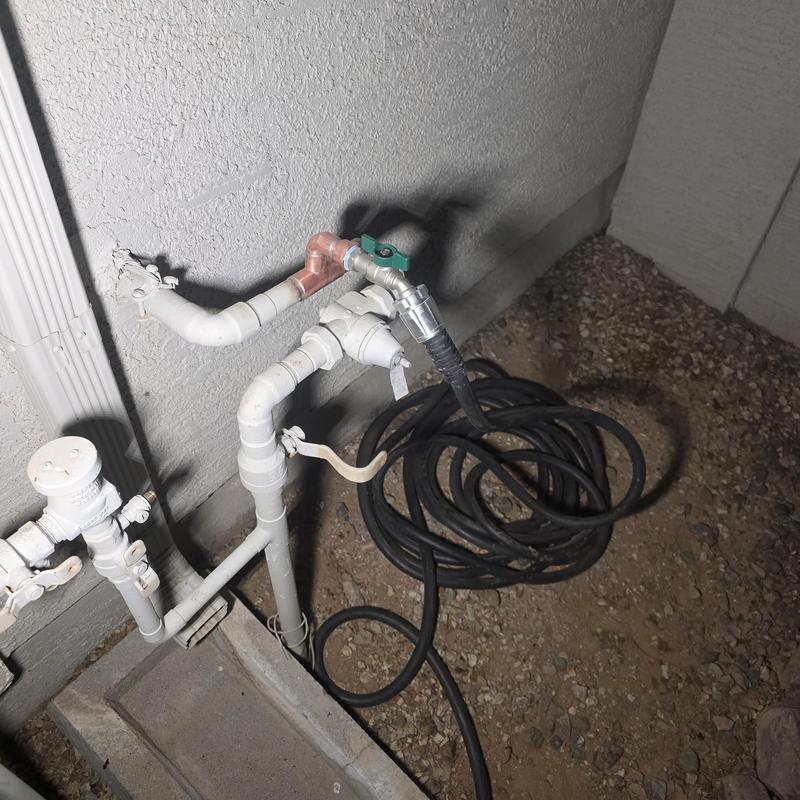 Water service bypass with temporary hose line outdoors