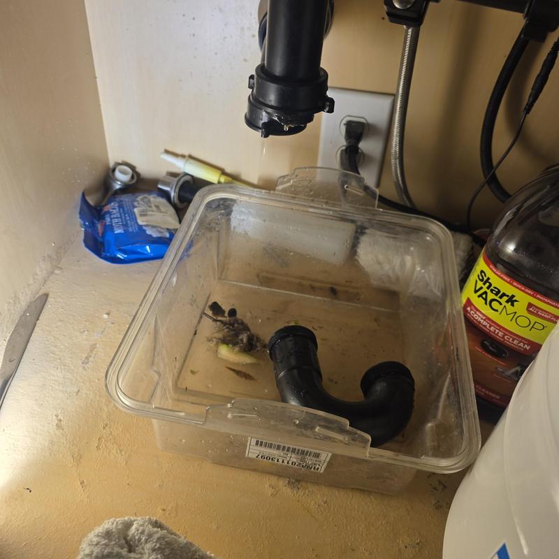Kitchen sink P-trap with clog and parts