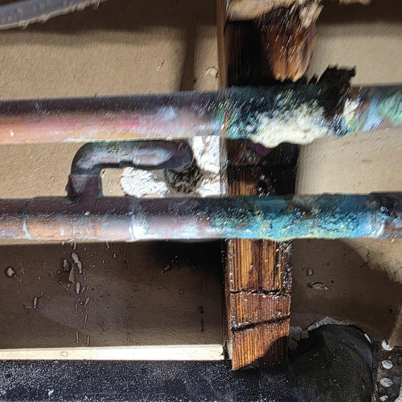 Hot copper water line with corrosion and leak damage