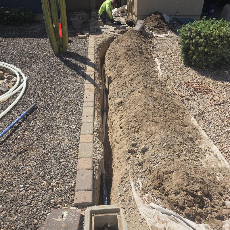 Water service line trench dug beside home for replacement
