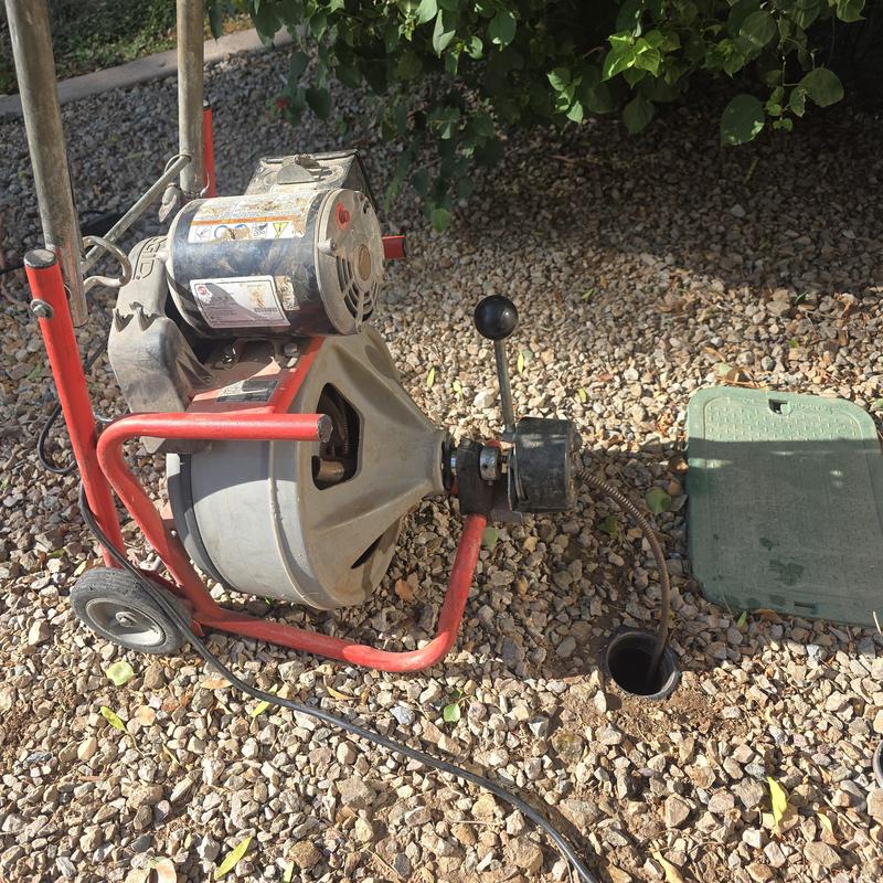 Main sewer line snaking with drain snake machine