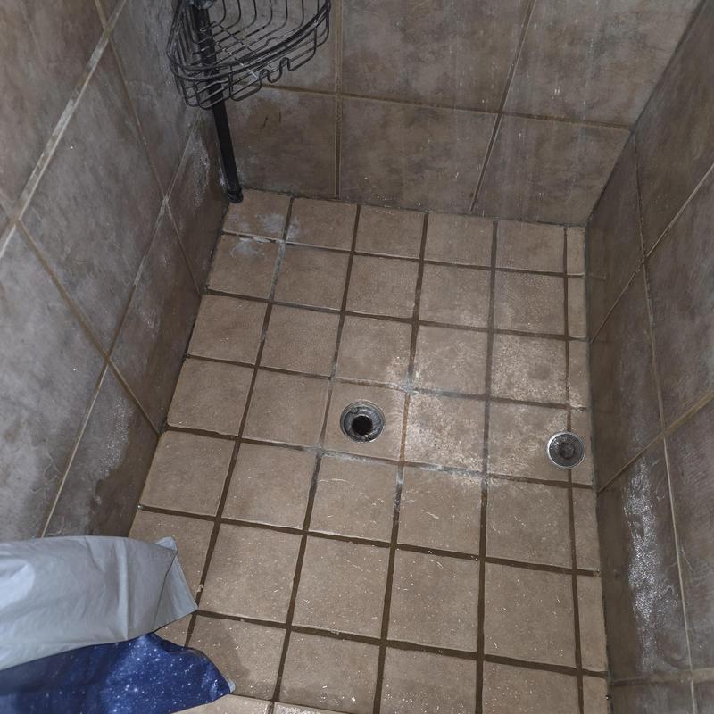 Shower drain and floor tile in tiled shower stall