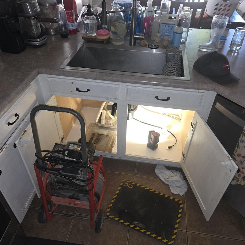 Kitchen sink drain with plumbing and rooter machine