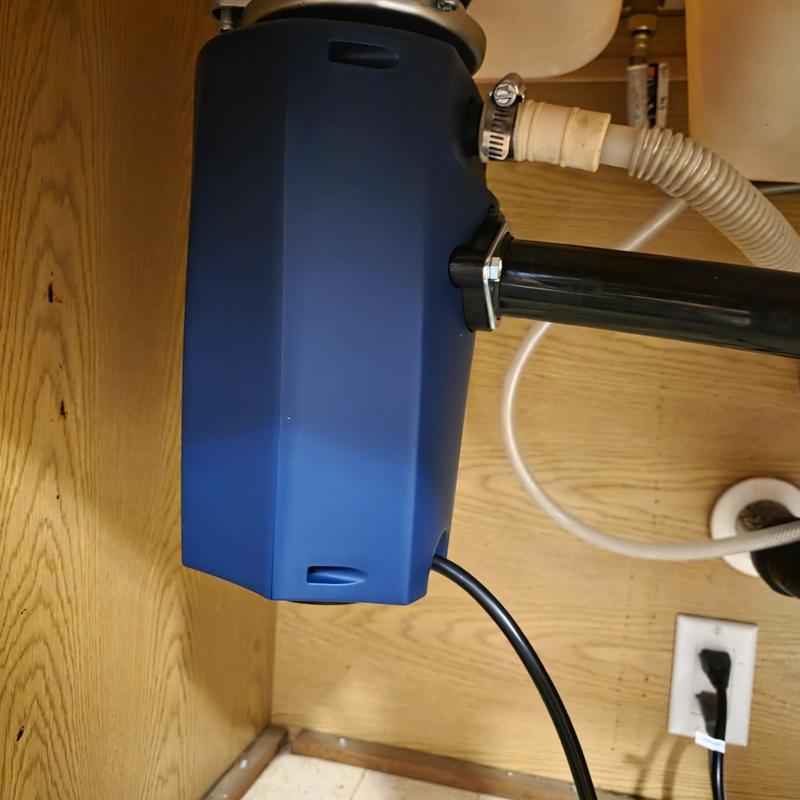 Garbage disposal unit with plumbing connections under sink